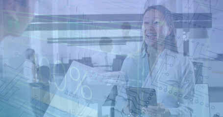 Image of numbers and loading over diverse female coworkers in office