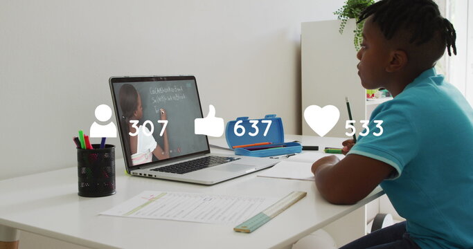 Profile, like and heart icons with increasing counters over african american boy studying online - Powered by Adobe