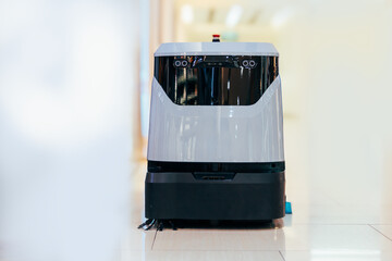 Automatic robot cleaner mopping of floor in commercial shop mall