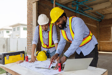 Construction workers collaborating on a building project at a construction site in the daytime