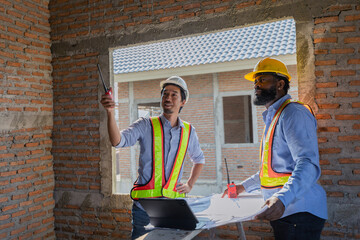 Construction workers collaborating on a building project at a construction site in the daytime