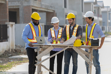 Construction workers collaborating on a building project at a construction site in the daytime