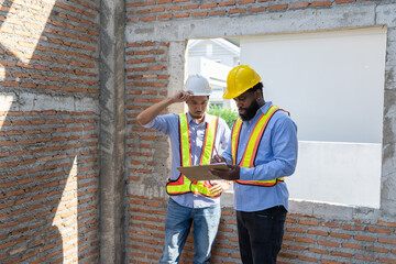 Construction workers collaborating on a building project at a construction site in the daytime