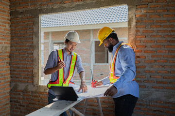 Construction workers collaborating on a building project at a construction site in the daytime