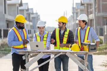 Construction workers collaborating on a building project at a construction site in the daytime