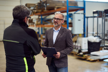 Professional Team Discussion in a Modern Warehouse Assessment Setting
