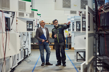 Engineers Discussing Factory Layout in a High-Tech Industrial Setting
