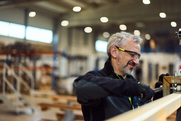 Professional Craftsman Working Diligently with Tools in a Workshop Environment