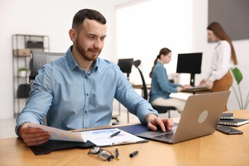 Handsome man working at desk in office