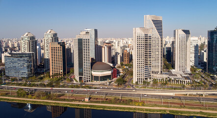 Fototapeta premium Urban cityscape with buildings along a Pinheiros river, and Marginal Pinheiros in Sao Paulo city.