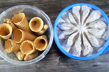 vanilla white frozen ice cream with cookies pieces, a vanilla ice cream with cookies in a flower shape and Ice cream biscuit cones, waffle biscuits used for ice cream, summertime concept