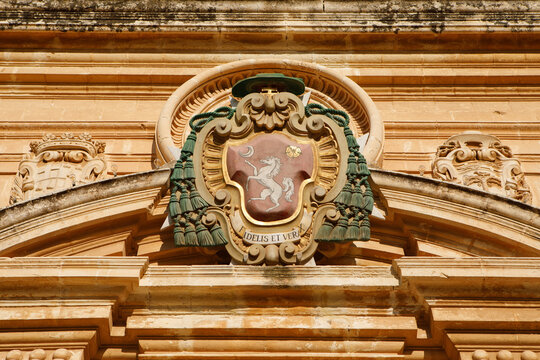 Historic Coat of Arms with "Fidelis et Verax" Inscription on Baroque Building Facade in Malta