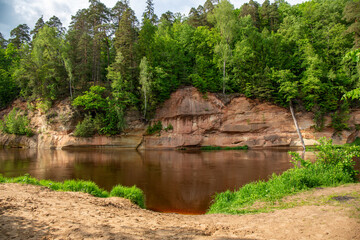 Velnala red cliffs at the river Gauja in Gauja national park in June in Sigulda in Latvia