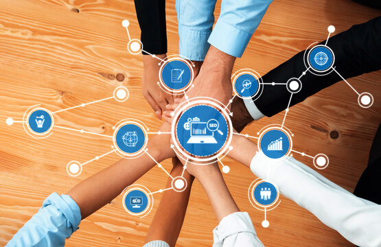 Engaging image depicting teamwork and collaboration, showcasing digital marketing icons related to SEO and analytics on a wooden desk, symbolizing business strategy and connection. Amity