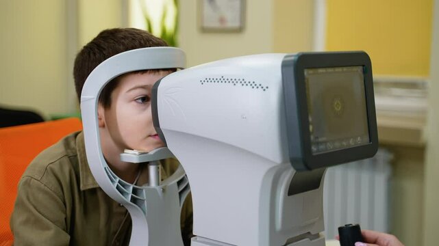 Young patient undergoing comprehensive eye examination with modern autorefractor