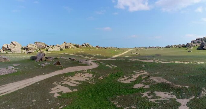Uninhabited area surrounded by rocks and boulders. Drone shoot of Gobustan, Azerbaijan