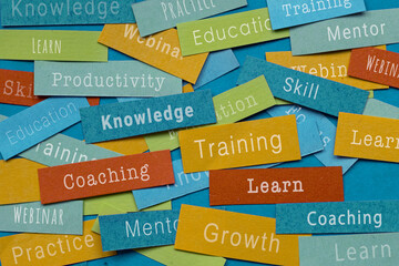 Training concept, learn new skills, coaching and education, cloud of words on colorful pieces of paper