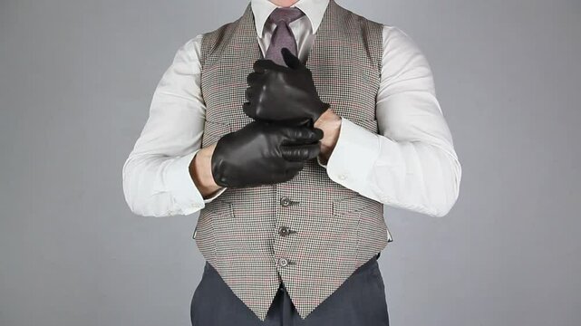 Vintage Ruffian or Back Alley Brawler Pulling on Leather Gloves and Punching His Hands. Threat of Violence and Danger.