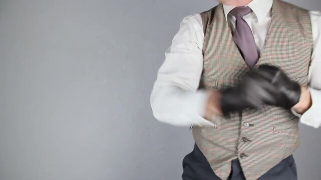 Vintage Ruffian in Waistcoat and Bowler Hat Pulling on Leather Gloves and Swinging His Fists Wildly