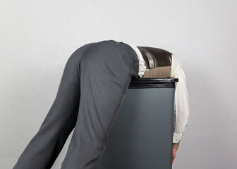 Businessman Thrown on Trash Can. Over a Barrel. Concept of Being Sacked or Fired.