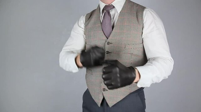 Vintage Ruffian or Back Alley Brawler Pulling on Leather Gloves and Standing in Fighting Stance With Fists Raised