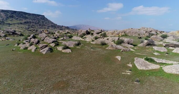 Uninhabited area surrounded by rocks and boulders. Drone shoot of Gobustan, Azerbaijan
