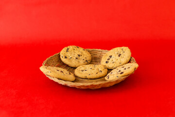 A basket of cookies on a red background