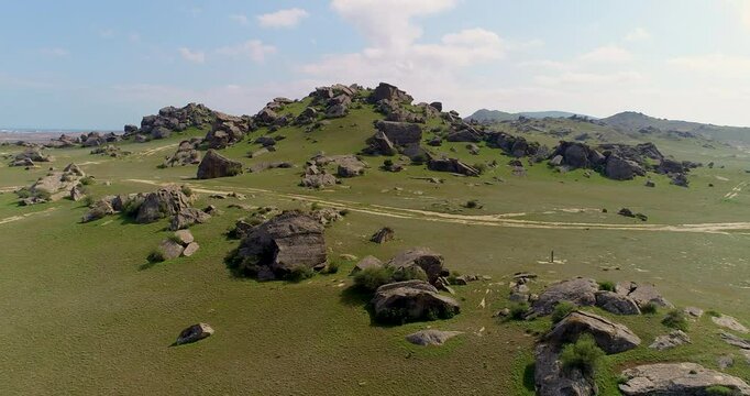 Uninhabited area surrounded by rocks and boulders. Drone shoot of Gobustan, Azerbaijan