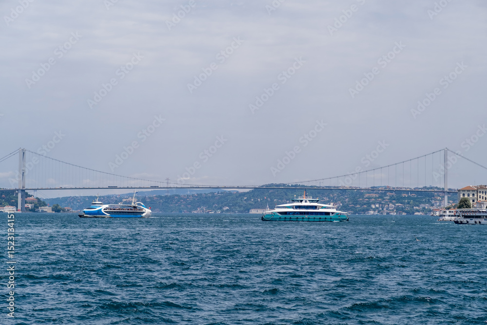 Aufkleber bosphorus waterway with ferries and the bridge connecting europe and asia under a cloudy sky during 