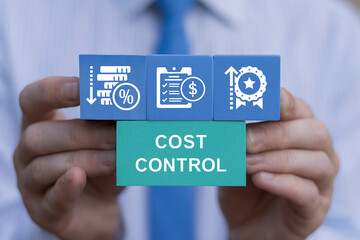 Business person holding colored blocks with icons sees text: COST CONTROL. Cost and quality control, industry strategy and project management concept. Cost reduction and effective manufacturing.