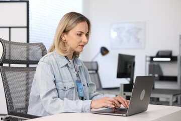 Engineer working with laptop at table in office