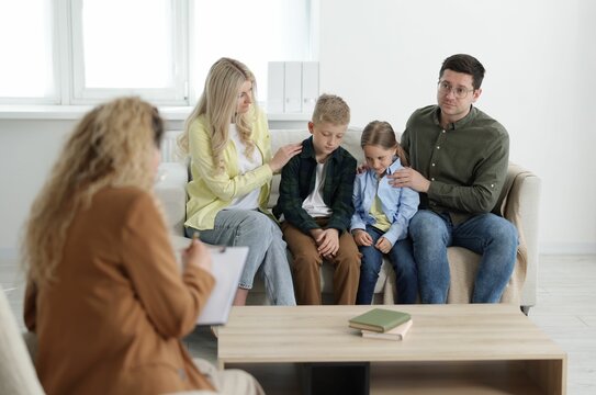 Family having consultation with psychologist in office - Powered by Adobe