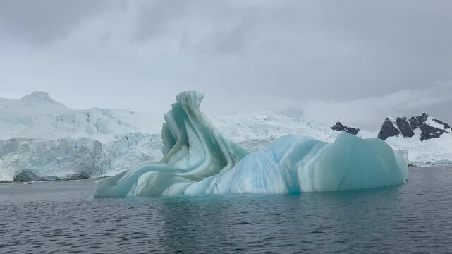 Big Iceberg in Antarctica Winter Scenery, Amazing Shape Ice Formation of Massive Large Enormous Blue Icebergs in Antarctic Peninsula Landscape Seascape with Ocean Sea Water