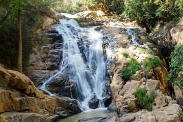 Fototapeta premium Majestic Tiger Waterfall Cascading Over Rocks in Lush Green Forest. Dalat, Vietnam.