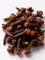 Obraz premium Pile of Dried Cloves on White Background