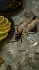  Dried Fish with Lemon Slices and Vodka Glasses