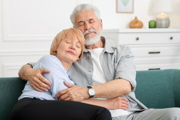 Fototapeta premium Lovely senior couple together on sofa at home