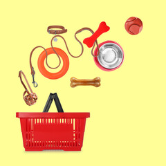 Different products for pets in air over shopping basket on yellow background