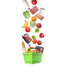 Food products falling into green shopping basket on white background