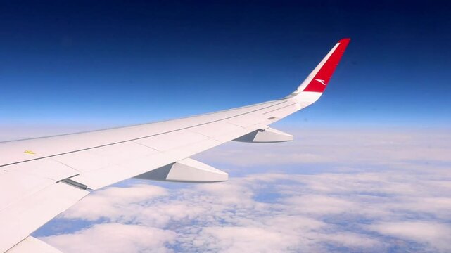 Vienna, Austria - April 7th 2025: Window View Over Wing from Austrian Plane at cruising altitude before landing in Vienna