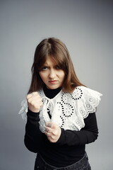 Angry Young Woman Clenching Fists, Ready to Fight