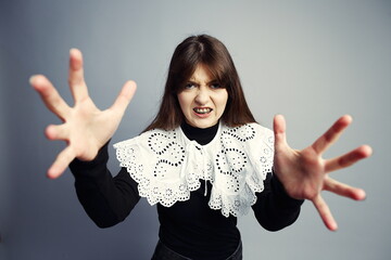 Fierce Young Woman Reaching Aggressively Towards Camera