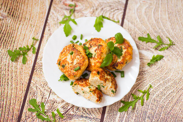 view of chicken cutlets with herbs on wooden table