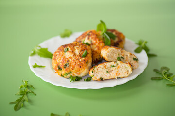 Juicy chicken cutlets in oil served for dinner isolated on green background