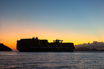 Container ship leaving the port of Santos during sunset