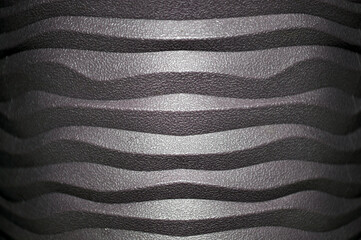 Close-up of a textured surface with wavy horizontal ridges. Abstract industrial or modern pattern...