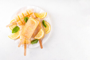 Iced tea or lemonade popsicles, sweet lemon and mint cocktail lollies