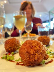Chinese Style Duck Bon Bons Served in Restaurant Setting with Wine