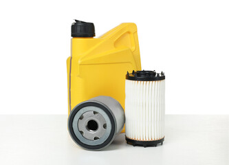 Motor oil in yellow canister and filters isolated on white