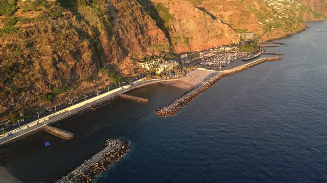 Aerial view of Calheta beach, marina and town at sunset, Madeira
